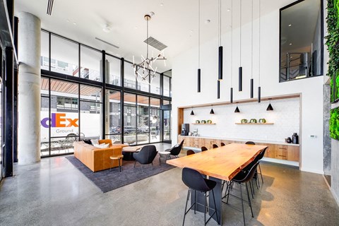 a large dining room with a wooden table and chairs