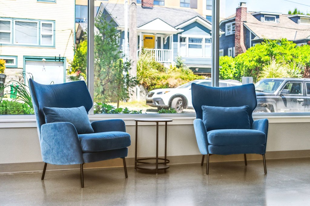 two blue chairs in front of a window