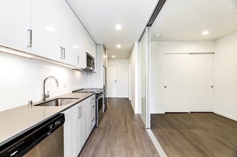 a kitchen with white cabinets and a sink and a counter top