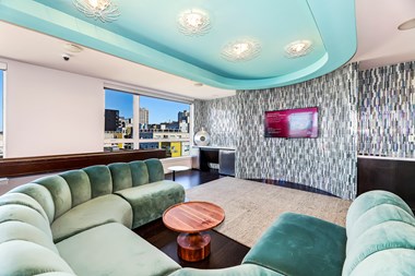 a living room with turquoise furniture and a large window