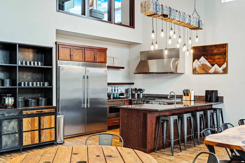 a kitchen with stainless steel appliances and a wooden table