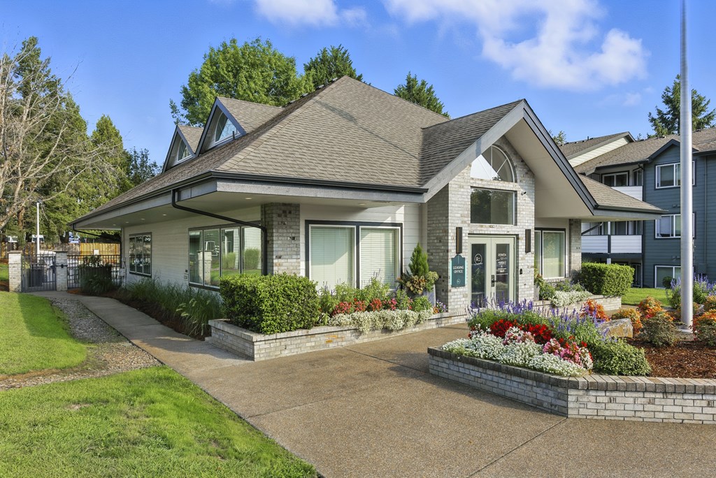 A house with a grey roof and a white front porch.