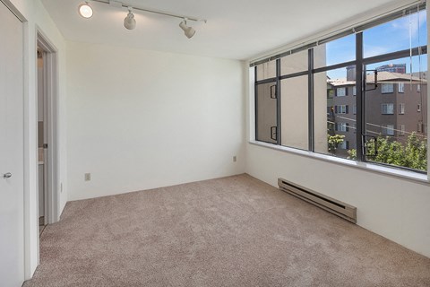 an empty living room with a large window