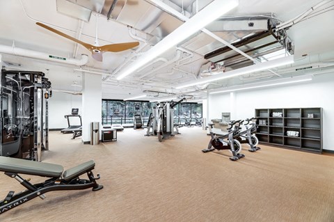 A spacious gym with a variety of equipment including treadmills, weights, and exercise bikes.
