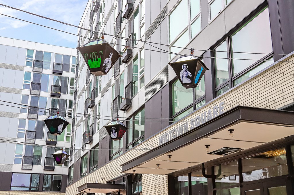 the facade of a building with hanging street lights