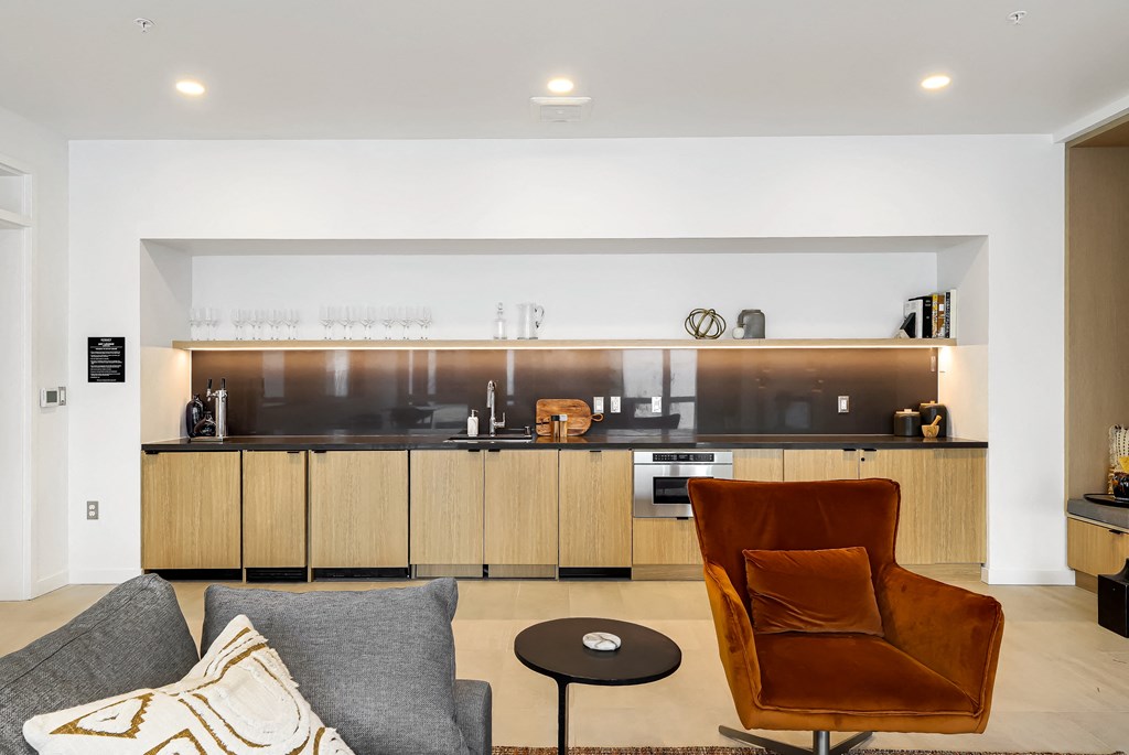 a living room with a couch and a kitchen in the background