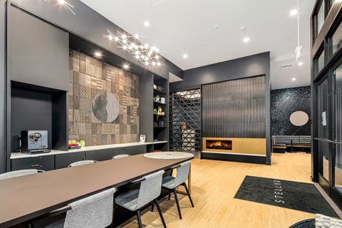 a dining room with a long table and chairs and a fireplace