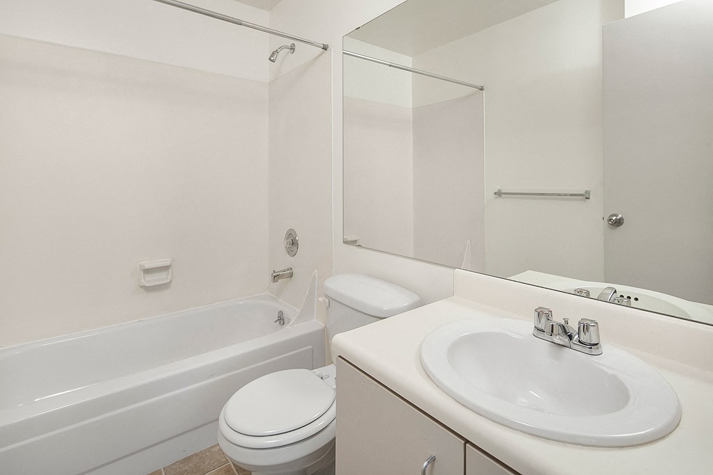 a bathroom with a sink toilet and a tub
