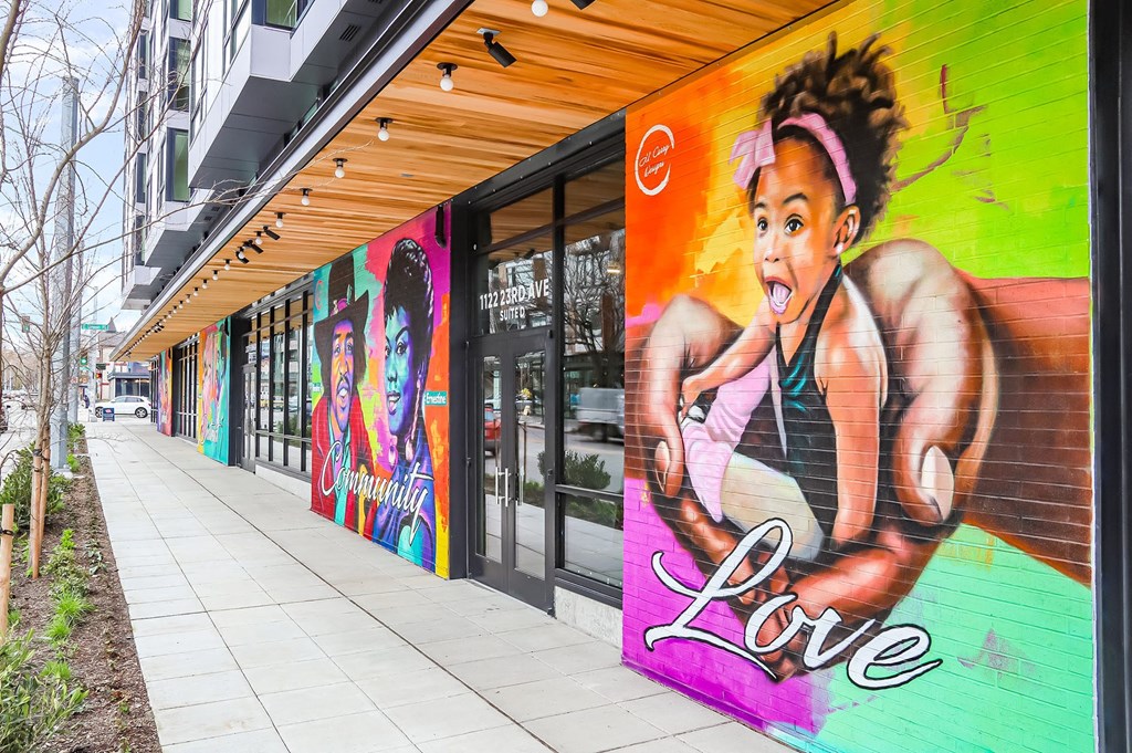 a mural of a woman saying love on the side of a building
