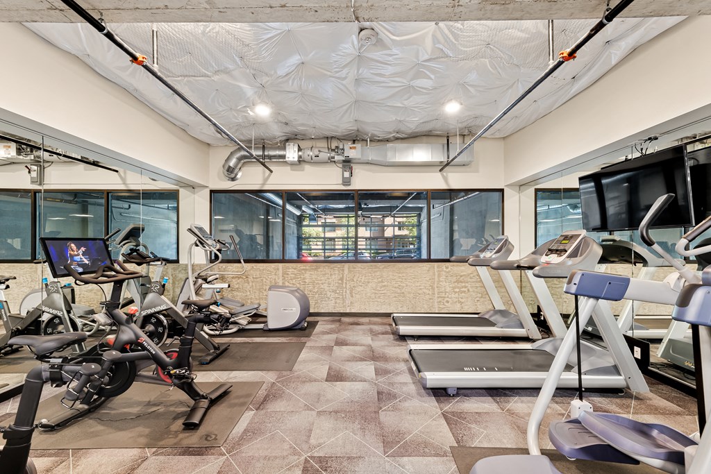 a gym with treadmills and other exercise equipment