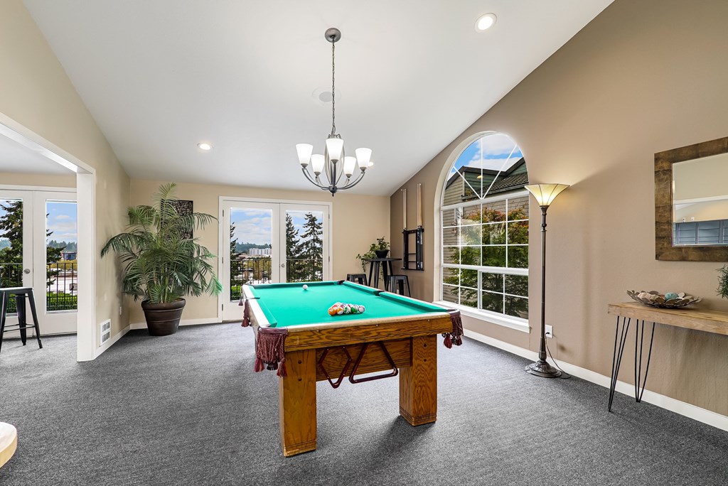 a large game room with a pool table