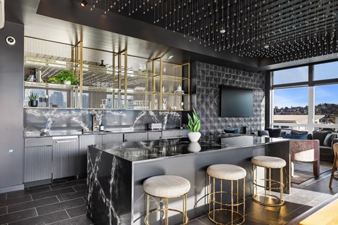 a kitchen with a counter and stools in a restaurant