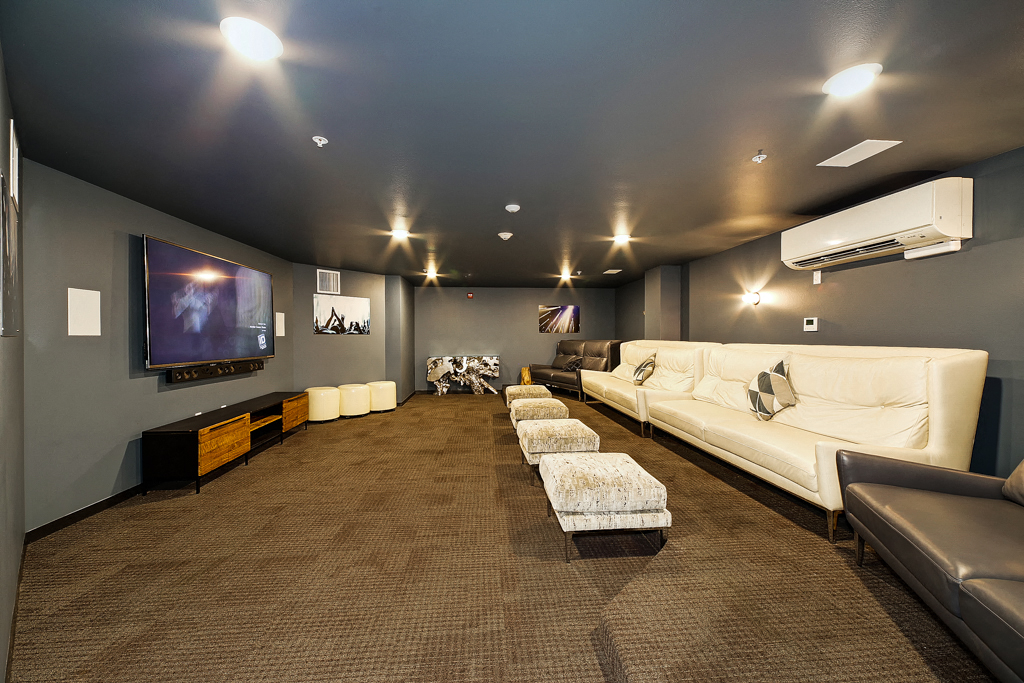 a large living room with couches and a tv