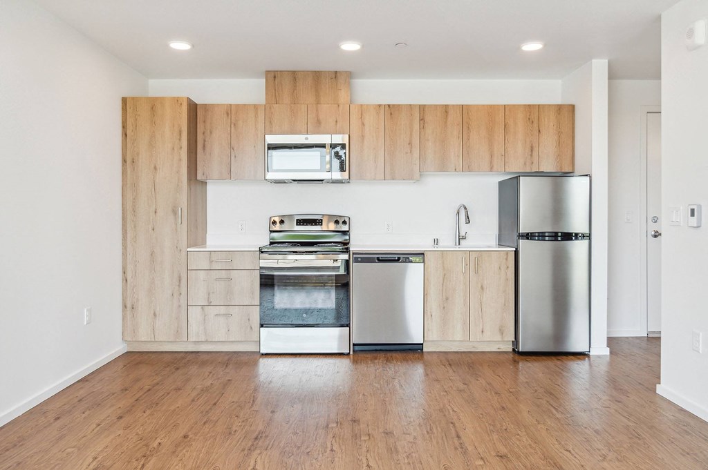 a kitchen with wooden cabinets and stainless steel appliances