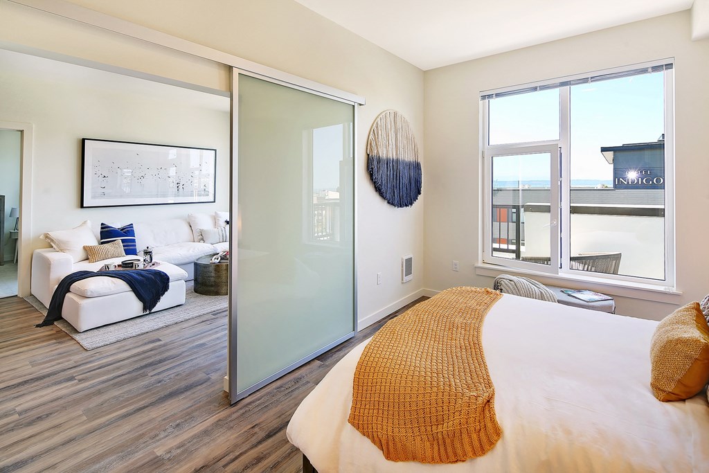 a bedroom with a large bed and a sliding glass door