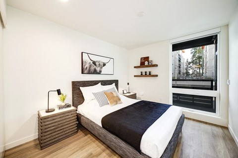 a bedroom with a bed and a window