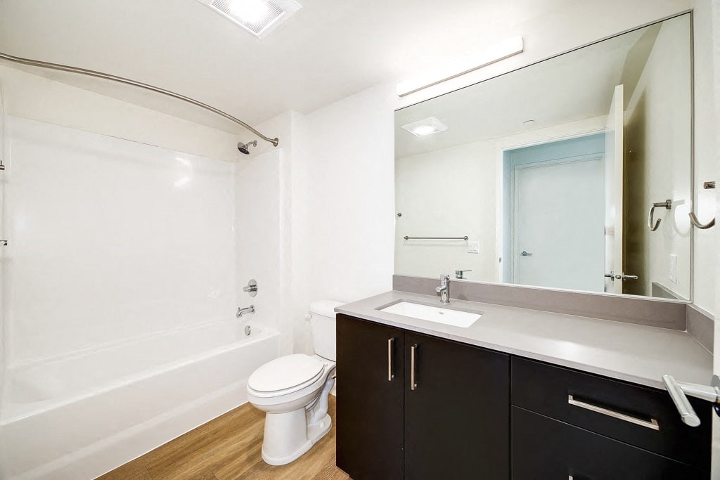 a bathroom with a sink toilet and a mirror