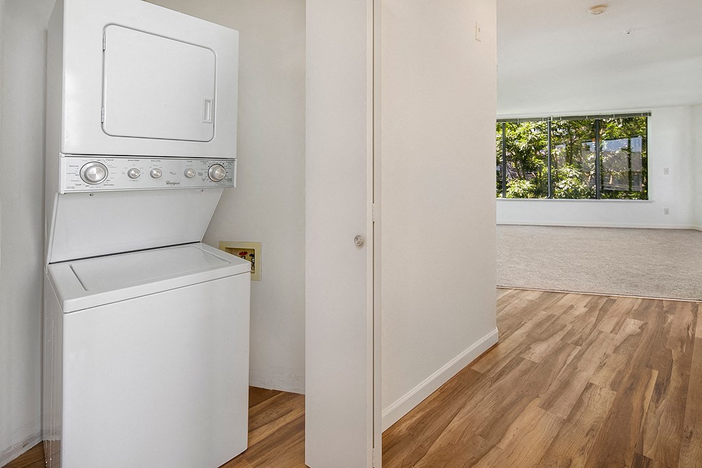 a laundry room with a washer and dryer and a window