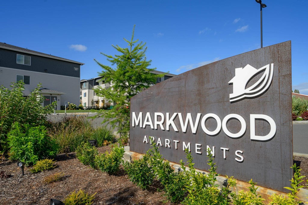 A sign for Markwood Apartments is shown in front of some buildings.