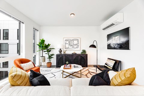 a living room with white walls and a couch and a tv