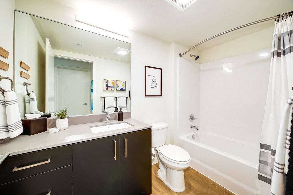 a bathroom with a sink toilet and a mirror