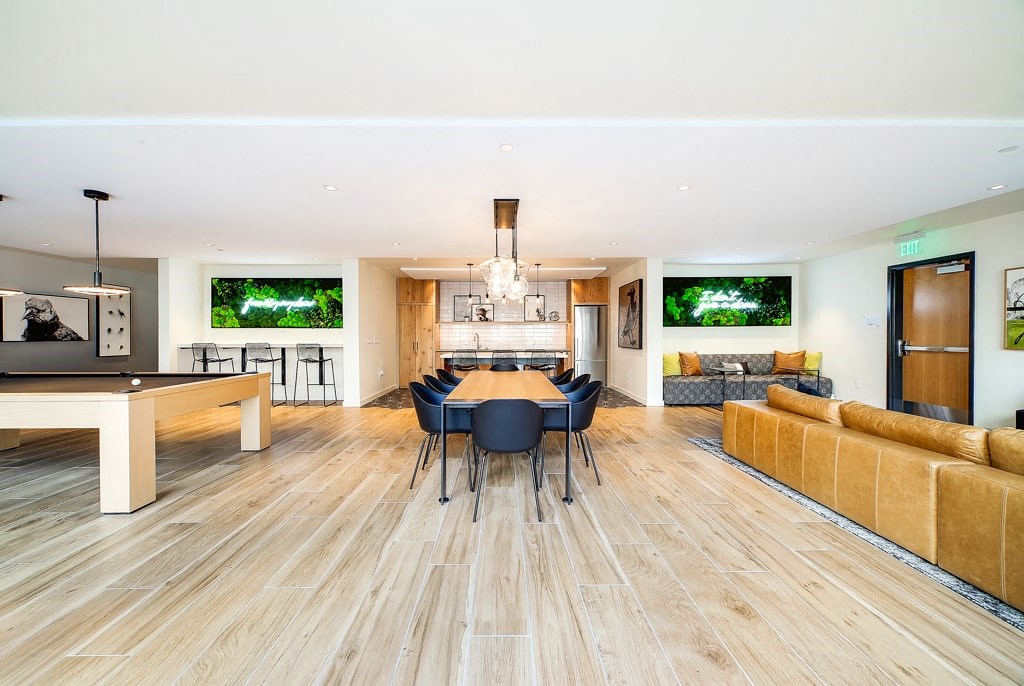 a living room and dining room with a table and chairs
