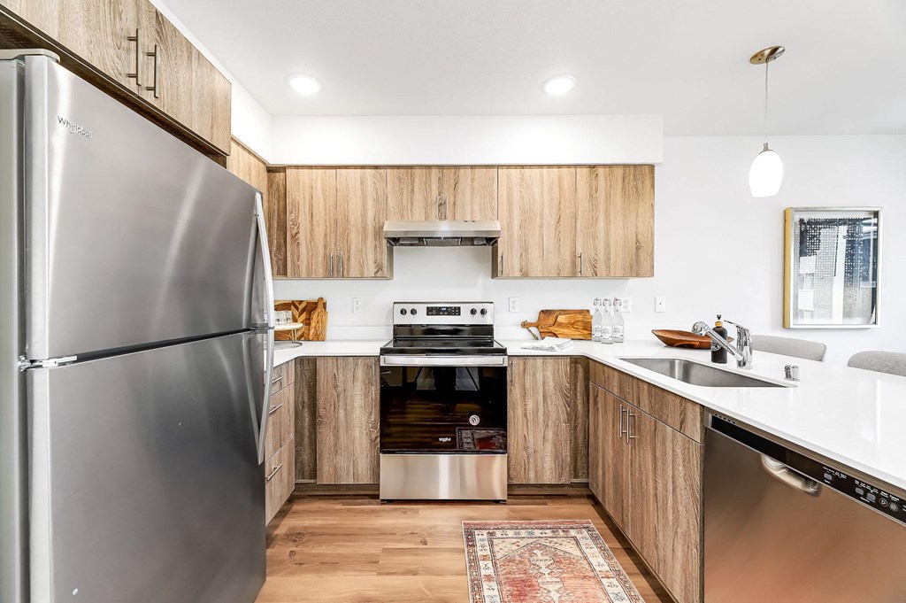 a kitchen with stainless steel appliances and wooden cabinets