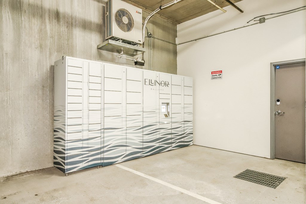 a large white room with a filing cabinet and a door