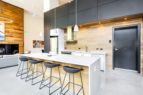 a kitchen with a large island and bar stools