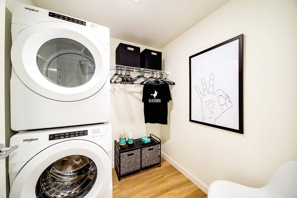 a laundry room with a washing machine and a closet
