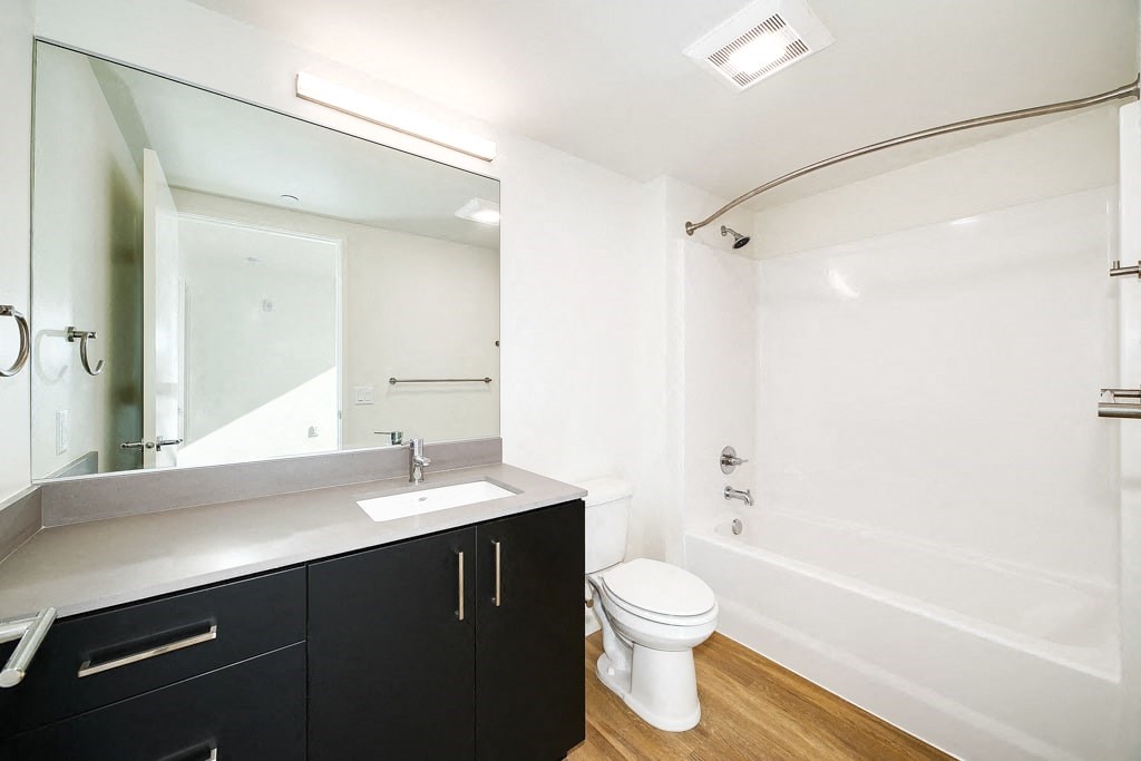a bathroom with a sink toilet and a mirror