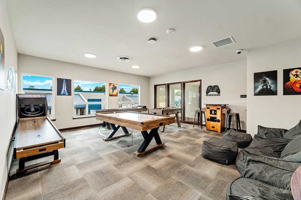 a game room with a pool table shuffleboard and foosball