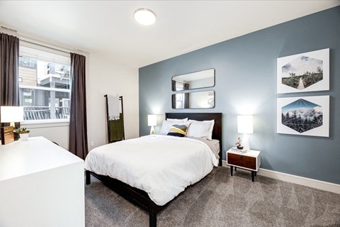 a bedroom with a large bed and a window