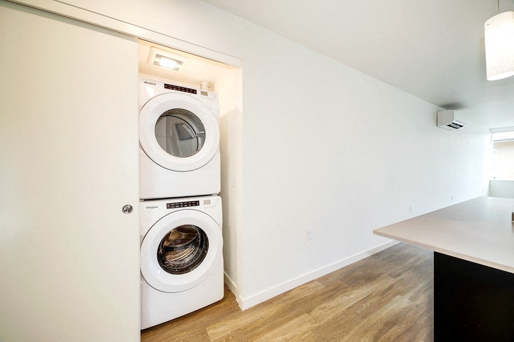 a white laundry room with a washer and dryer in it