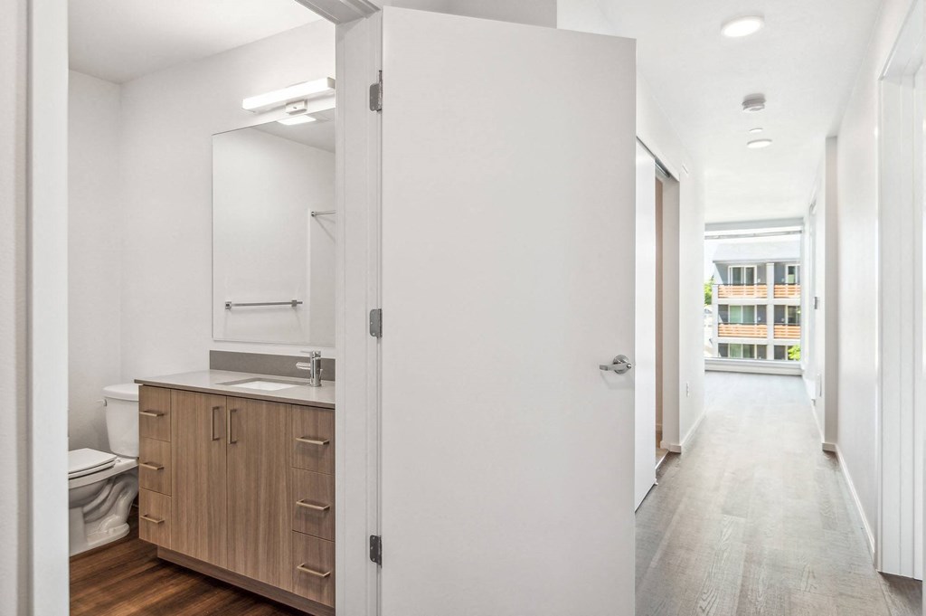 a bedroom with a medium sized bed and a mirror