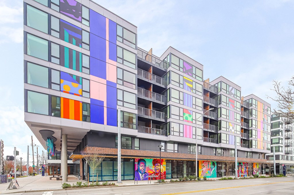 a building with colorful windows and a street in front of it