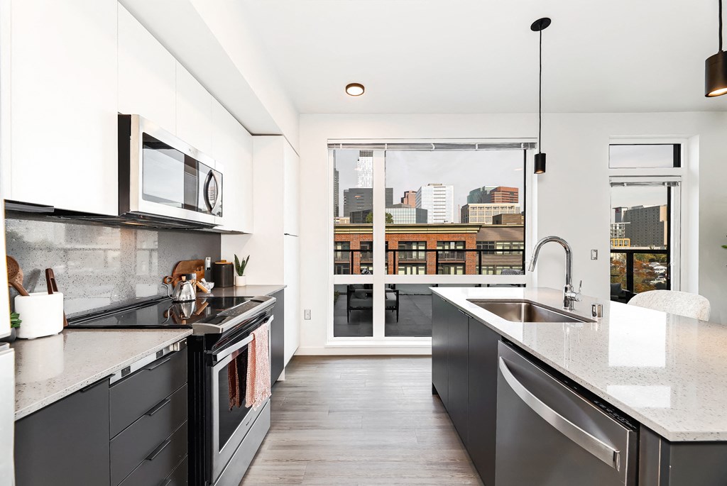 a kitchen with a large window and a sink and a counter top