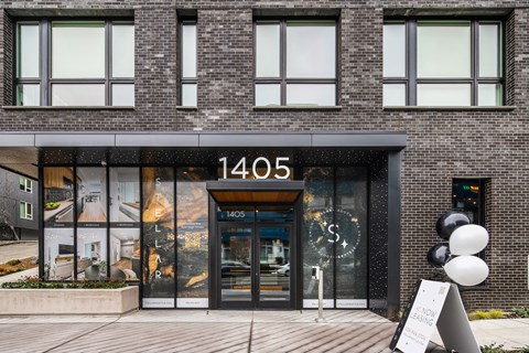 the front of a building with balloons in front of it
