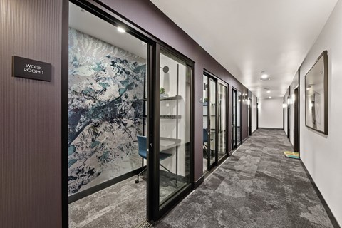 a hallway with glass doors and a mural on the wall