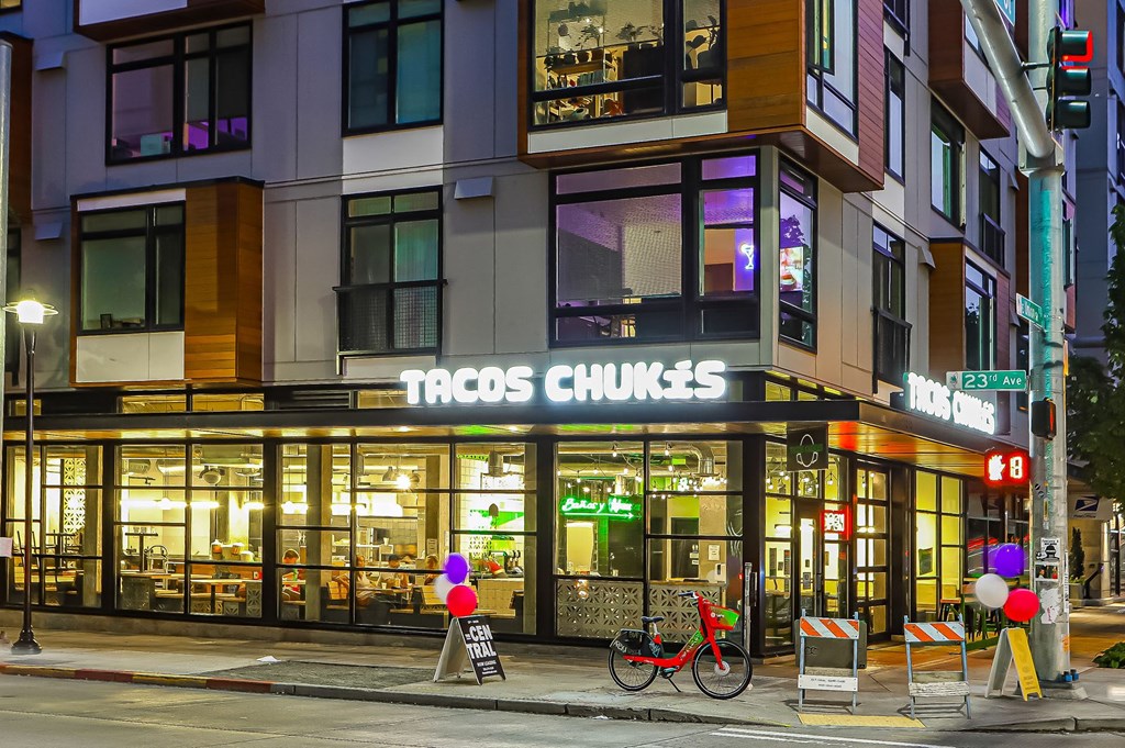A Tacos Charges restaurant is located on the corner of a street.