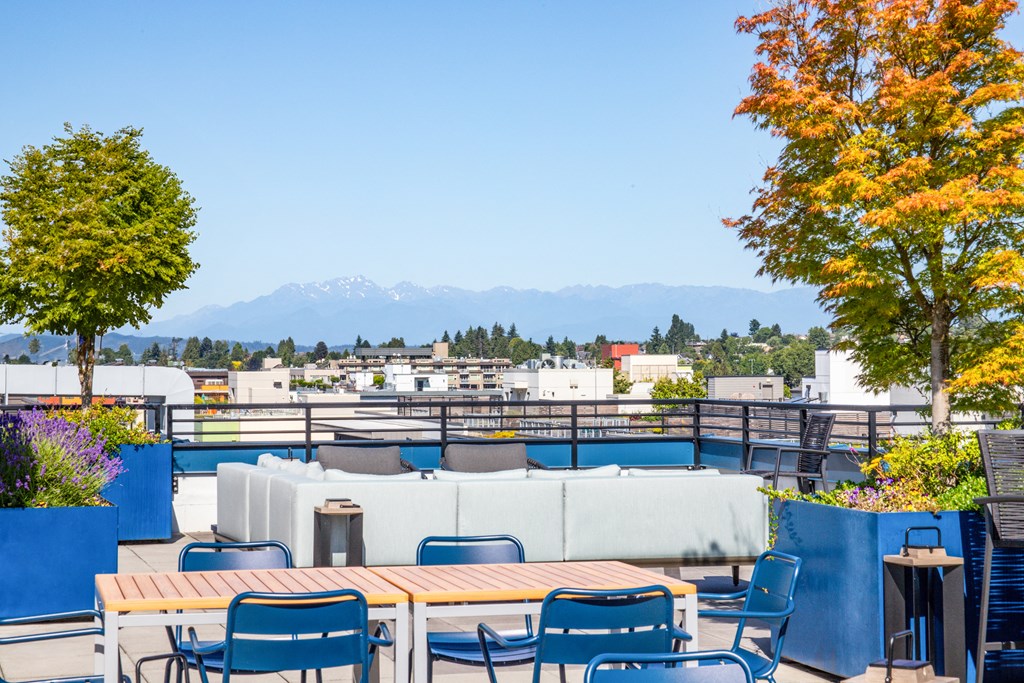a view of the mountains from a roof top patio