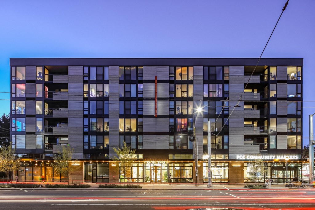 an evening view of an apartment building on a city street