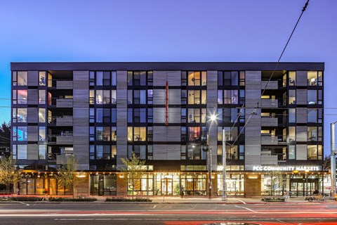 an evening view of an apartment building on a city street