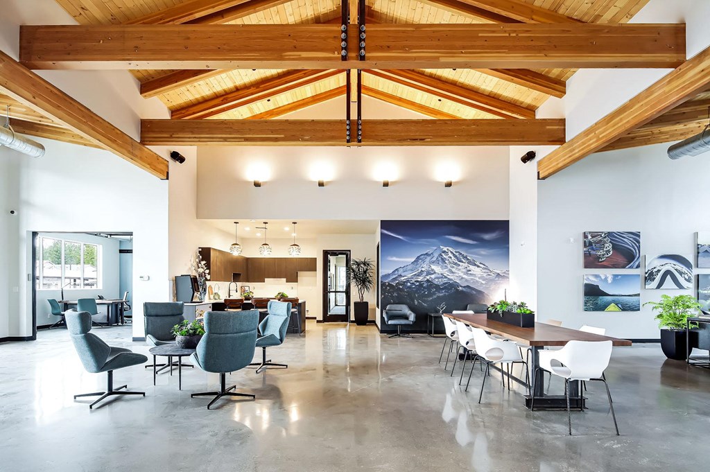 the lobby of a building with tables and chairs