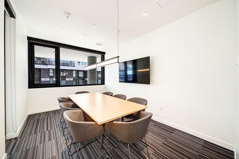 a conference room with a table and chairs