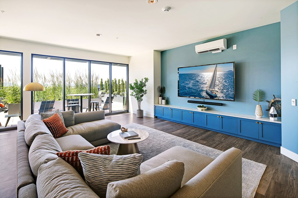 a living room with blue walls and a large screen tv