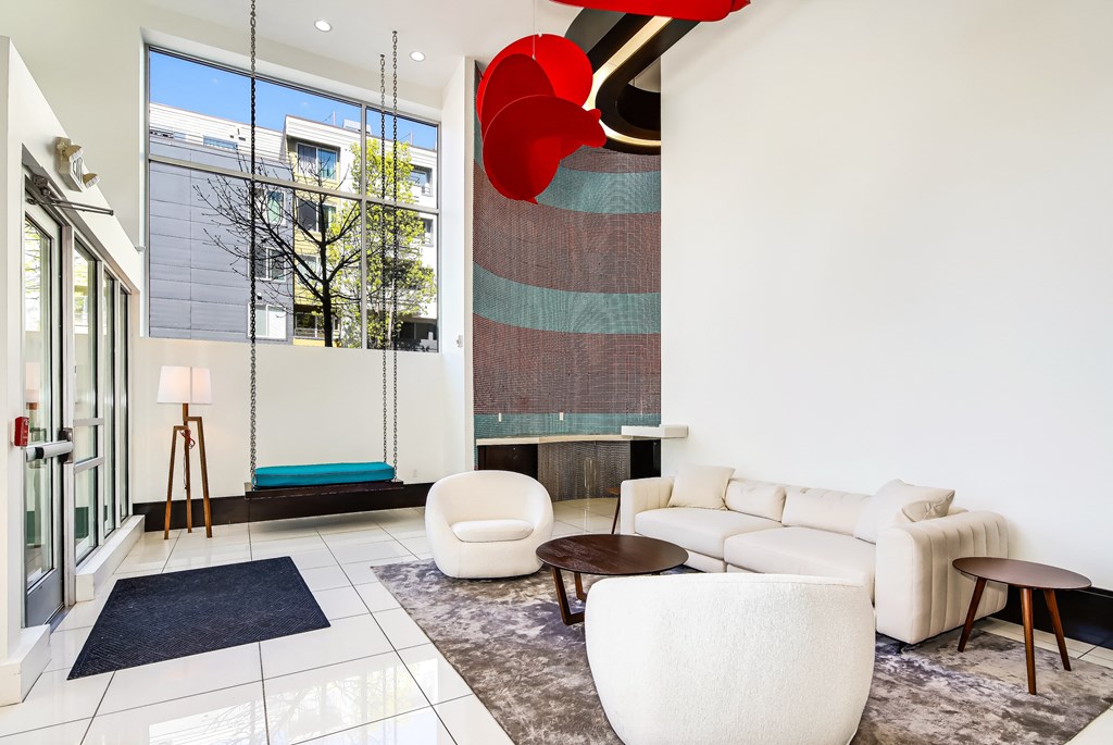 a living room filled with furniture and a large window
