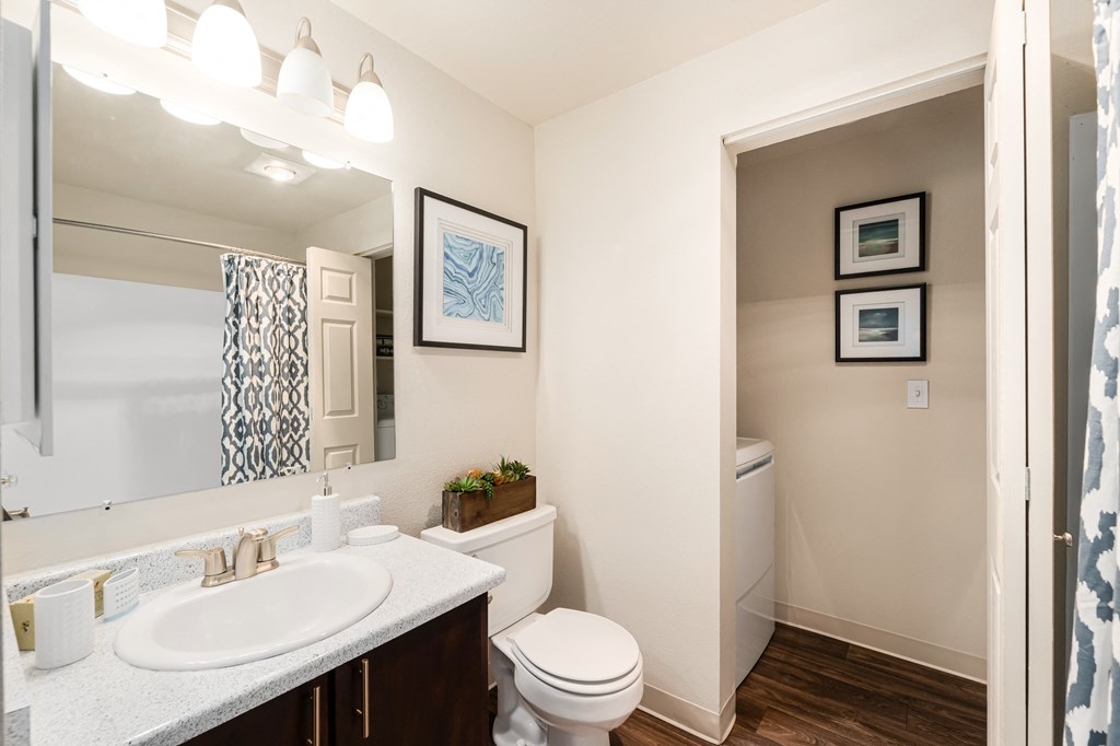 a bathroom with a large mirror and a toilet and sink