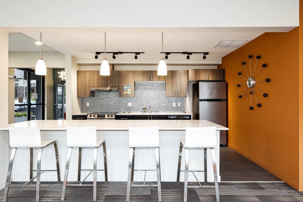 a modern kitchen with a counter and bar stools