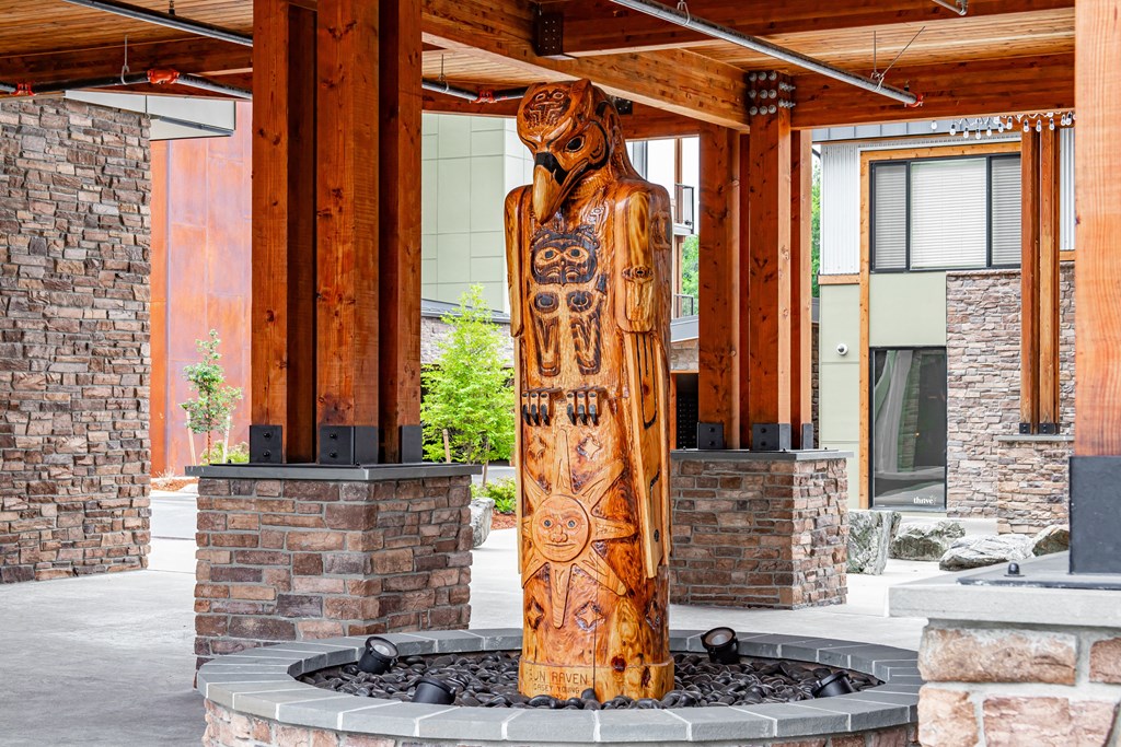 a totem pole in front of a building